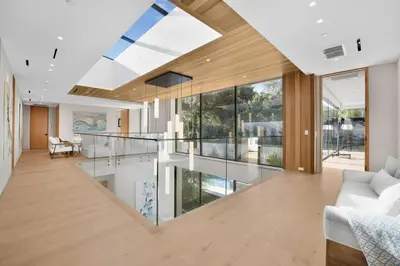 a living room with a large glass ceiling and a white couch at Hutton Villa in Los Angeles