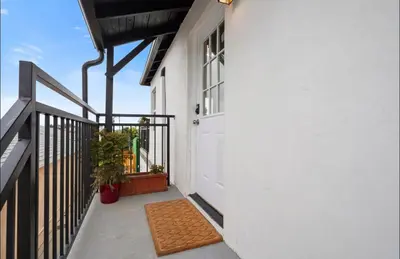 a balcony with a white door and a window at Twilight Terrace - Telescope - 15 Min to Beach in Hawthorne