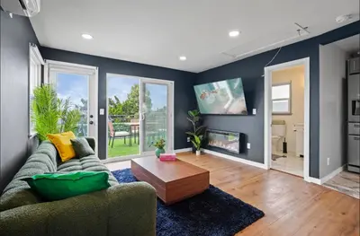 a living room with a couch and a table at Twilight Terrace - Telescope - 15 Min to Beach in Hawthorne
