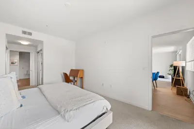 a white bedroom with a bed and a mirror at The Iris-Modern 3BD in the Heart of Marina del Rey-Pool,Gym,Jacuzzi-Near LAX in Los Angeles