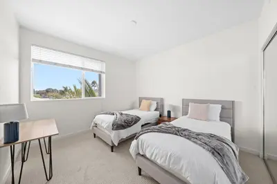a white bedroom with two beds and a window at The Iris-Modern 3BD in the Heart of Marina del Rey-Pool,Gym,Jacuzzi-Near LAX in Los Angeles
