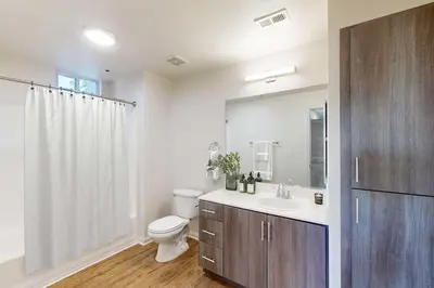 a bathroom with a sink and a toilet and a mirror at Deluxe Living in Marina Del Rey - Pool, Hot Tub, Gym in Los Angeles