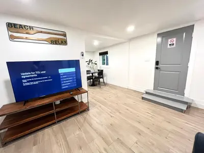 a living room with a large flat screen tv on a table at remodeled 2b 1b house Rosemead c in Rosemead