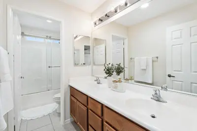 a bathroom with a sink and a toilet and a mirror at Desert Family Oasis 4BR Near Trails Attractions in Palmdale