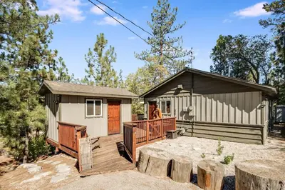 a tiny house with a deck and a building at Walk to Village & Alpine Slide - Almost a View in Big Bear Lake