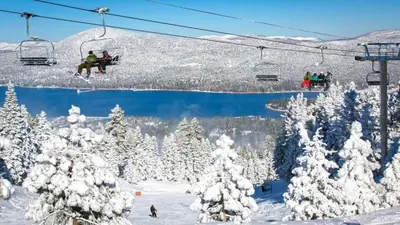 a group of people riding a ski lift in the snow at Walk to Village & Alpine Slide - Almost a View in Big Bear Lake