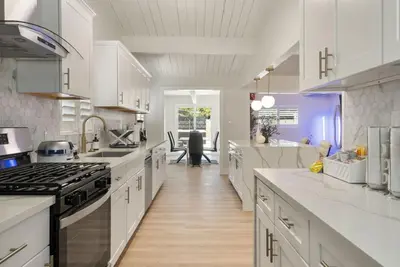 a kitchen with white cabinets and a stove top oven at Jedi Retreat-10mins to Disney-Hot Tub-Big Group in Anaheim