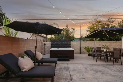a patio with chairs and tables and umbrellas at Lightsaber Lounge-Hot Tub-Billiards-10mnstoDisney in Anaheim