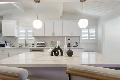 a kitchen with white cabinets and a white counter top at Lightsaber Lounge-Hot Tub-Billiards-10mnstoDisney in Anaheim