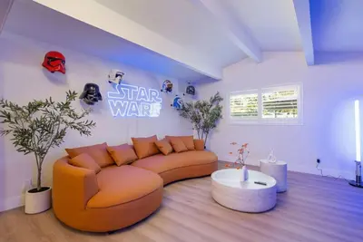 a living room with a couch and a star wars sign at Lightsaber Lounge-Hot Tub-Billiards-10mnstoDisney in Anaheim