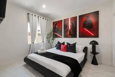 a bedroom with a large bed with posters on the wall at Darth Vaders Lair - 10 mins to Disney - Sleeps 6 in Anaheim