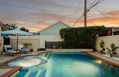 a swimming pool in the backyard of a house at Cascade Cove - Heated Pool Spa - Billiards and Lounge in Long Beach