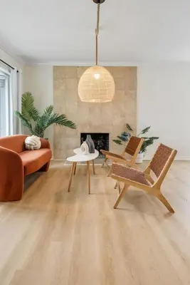 a living room with a couch and chairs and a fireplace at Stunning Retro Beach Oasis, Dual Living, Pool in Long Beach