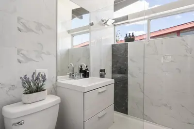 a bathroom with a toilet and a sink and a shower at Galactic Getaway Close to Disney with Pool and Games in Anaheim