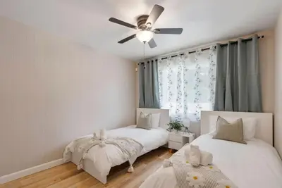 a bedroom with two beds and a ceiling fan at Aqua Oasis - Games - Close to DT - Sleeps 10 in Montebello