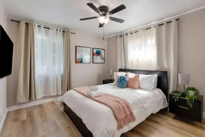 a bedroom with a bed and a ceiling fan at Aqua Oasis - Games - Close to DT - Sleeps 10 in Montebello