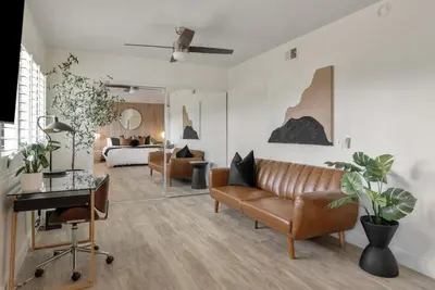 a living room with a couch and a table at 2-Story Sanctuary - Spacious Hot Tub - Billiards in Los Angeles