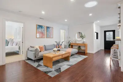 a living room with a couch and a table at Coastal Lagoon - Pool Heating - Games - Air Hockey in Long Beach