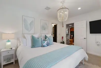 a bedroom with a large bed with blue pillows at Coastal Lagoon - Pool Heating - Games - Air Hockey in Long Beach