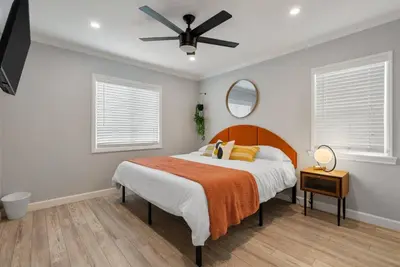 a bedroom with a bed and a ceiling fan at Luxury Hangout - Private Spa - Game Room - Arcade in Long Beach