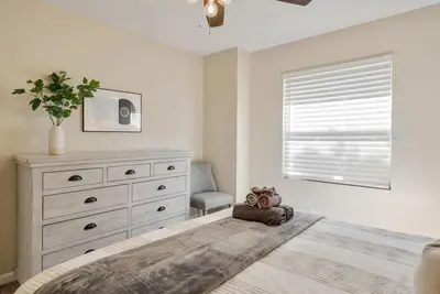 a bedroom with a bed and a dresser and a window at Surfers Dreams - 5min Drive to Beach with PoolTable in Long Beach