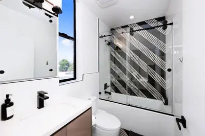 a bathroom with a sink and a toilet and a window at Trendy Chic in Los Angeles