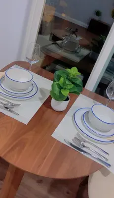 a wooden table with blue and white plates on it at Woodland Hills 1 Bedroom Getaway in Woodland Hills