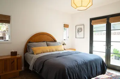 a bedroom with a large bed with a wooden headboard at Spanish-style garden Bungalow in Burbank
