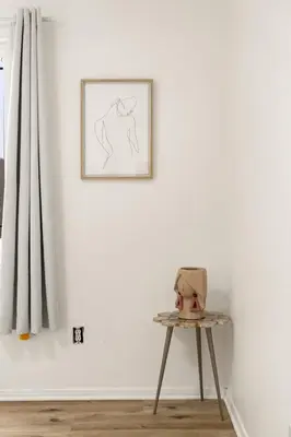 a table in front of a white wall with a picture at Casa Lanzit - 35 Percent Off March 2026! in Los Angeles