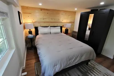 a bedroom with a large bed and two lamps at The Train Getaway Big Bear Lake in Big Bear Lake