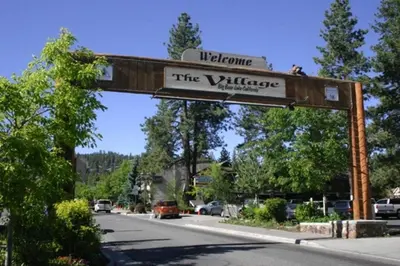 a sign for the village on the side of a road at The Train Getaway Big Bear Lake in Big Bear Lake