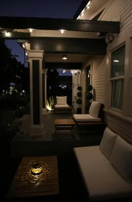a patio at night with a couch and a table at Historic Heart of Hollywood *Newly Renovated * in Los Angeles