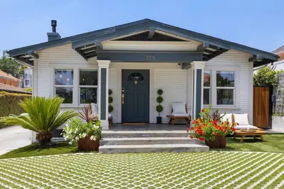 a small white house with a blue door at Historic Heart of Hollywood *Newly Renovated * in Los Angeles