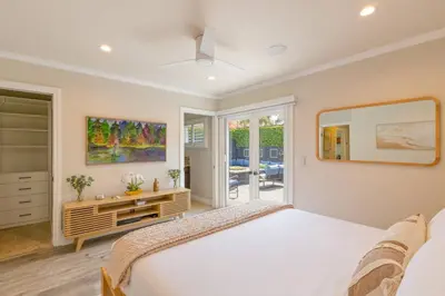 a bedroom with a white bed and a mirror at Historic Heart of Hollywood *Newly Renovated * in Los Angeles