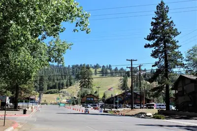 an empty street with a mountain in the background at Summit Ski Shack in Big Bear Lake