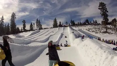 a group of people on a snow covered slope at Summit Ski Shack in Big Bear Lake