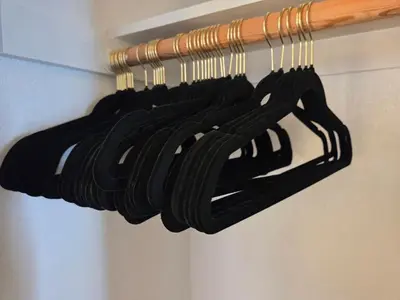 a bunch of black hangers in a closet at Minimalist Lake House in Helendale