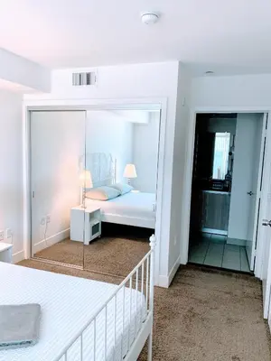 a bedroom with a bed and a mirror at Western Melrose in Los Angeles
