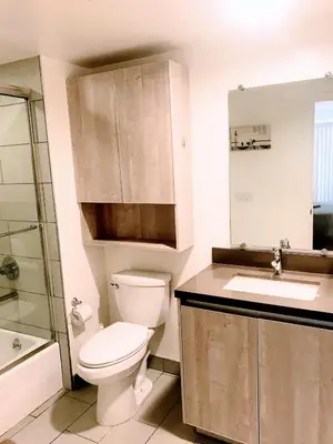 a bathroom with a toilet and a sink at Western Lemon Grove in Los Angeles