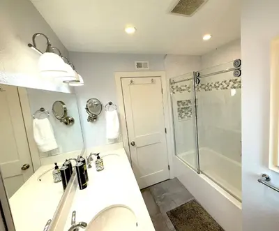 a bathroom with a shower and a sink and a toilet at Mountain View • Pool House in Chino Hills
