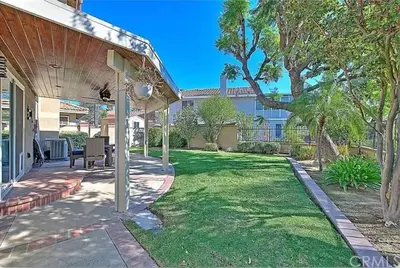 a backyard with a grass yard with a house at Mountain View • Pool House in Chino Hills