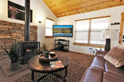 a living room with a couch and a fireplace at Take a Break in Big Bear Lake