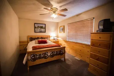a bedroom with a bed and a ceiling fan at Luxury w Spa Foosball Near Summit - DeCarlo House in Big Bear Lake