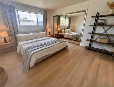 a bedroom with a large bed and a large mirror at Santa Monica 2BR Condo Views and Prime Location in Los Angeles