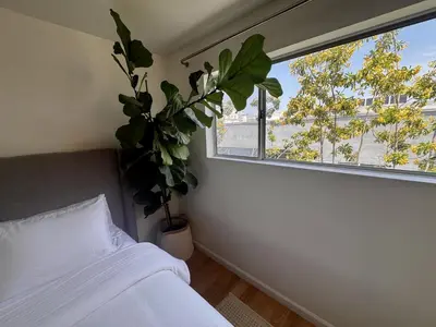 a bedroom with a bed and a window with a plant at Santa Monica 2BR Condo Views and Prime Location in Los Angeles
