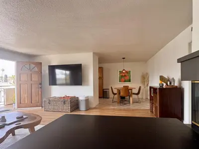 a living room with a tv and a table at Santa Monica 2BR Condo Views and Prime Location in Los Angeles