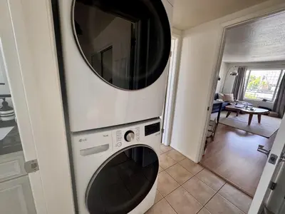 a washer and dryer in a kitchen with a mirror at Santa Monica 2BR Condo Views and Prime Location in Los Angeles