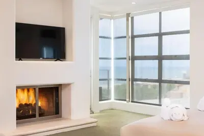 a living room with a fireplace and a tv at Stunning Panoramic Ocean Views Penthouse Hot Tub in Manhattan Beach