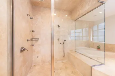 a bathroom with a shower with a glass door at Stunning Panoramic Ocean Views Penthouse Hot Tub in Manhattan Beach