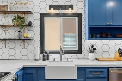 a kitchen with blue cabinets and a sink and a window at Charming 2BR in Heart of LA with Spacious Backyard in Los Angeles
